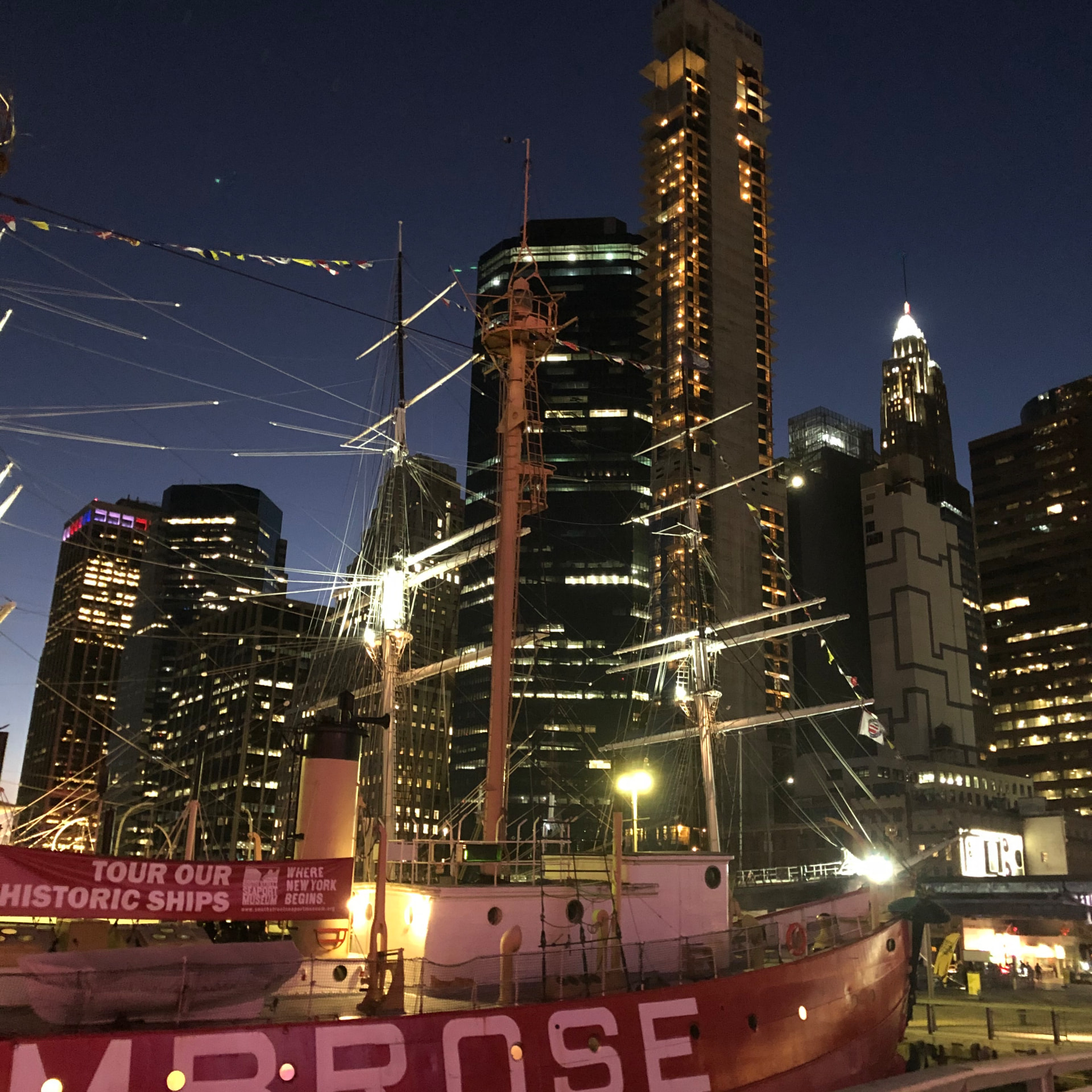 New York waterfront beneath the illuminated nighttime skyline